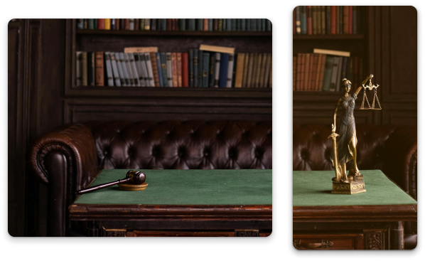 Wooden gavel on a green desk in a law office, with a statue of Lady Justice nearby.